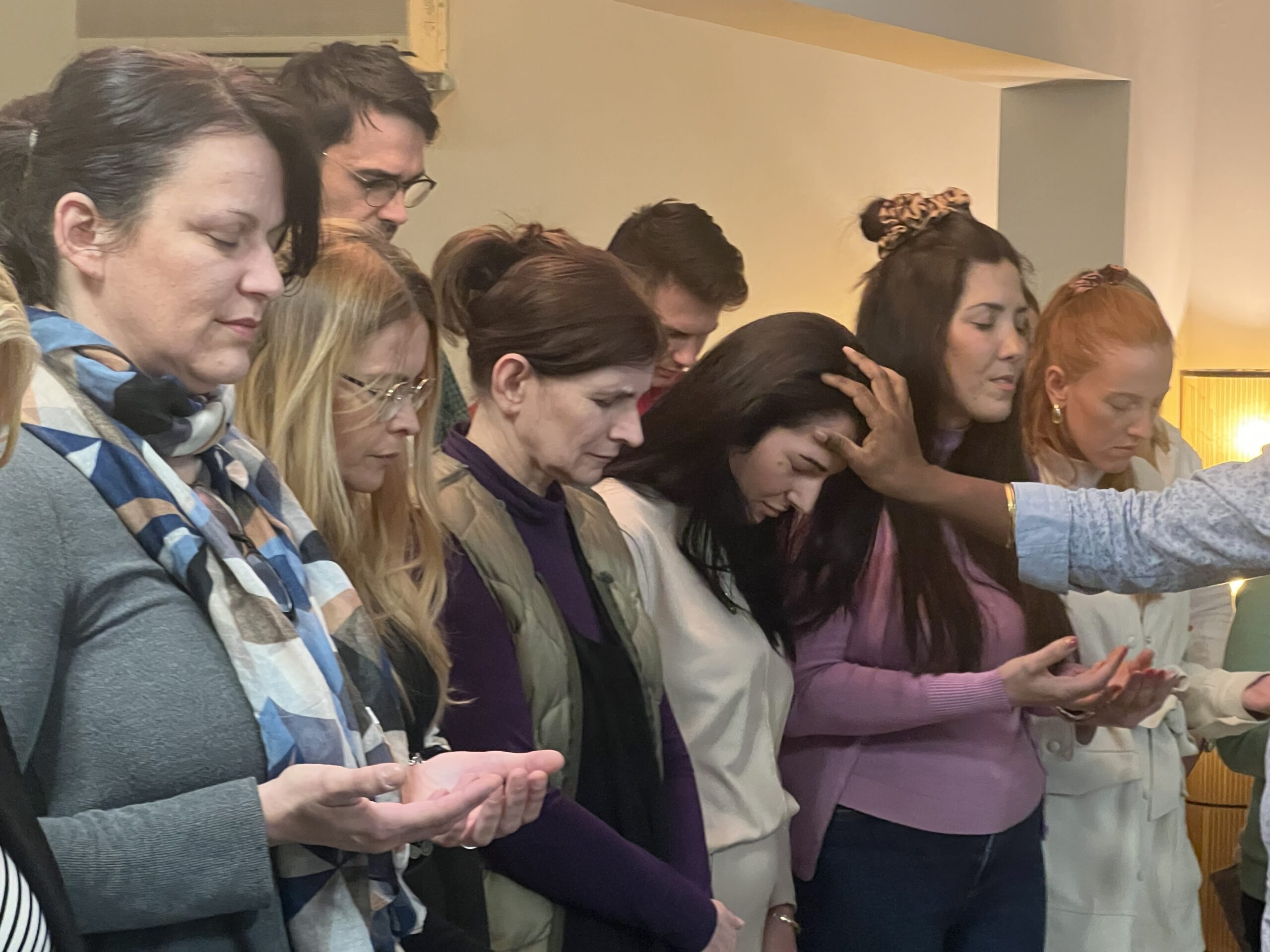 Ravi Kandal praying with people during a Kingdom Foundations gathering